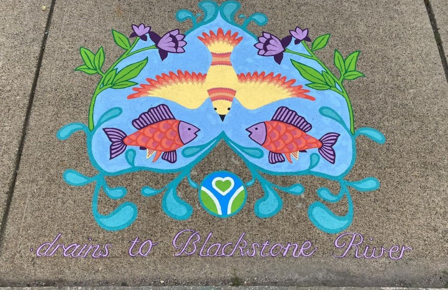 Bright and decorative mural showing a yellow bird and purple flowers above two orange fish in blue water. Text at the bottom reads “Drains to Blackstone River.”