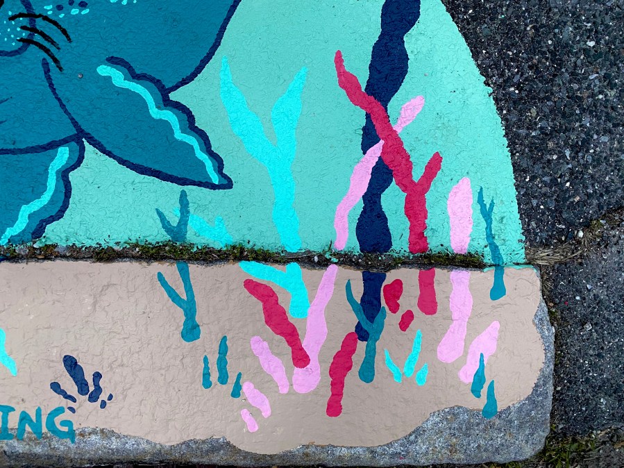 Another close-up section of the mural highlighting the coral, seaweed, and the playful seal’s tail above the “NO DUMPING” message.